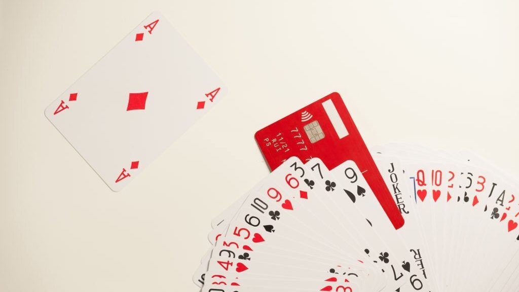 The deck of playing cards and a red credit card imitating a joker