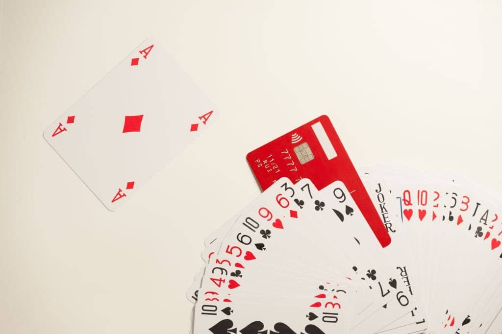 The deck of playing cards and a red credit card imitating a joker